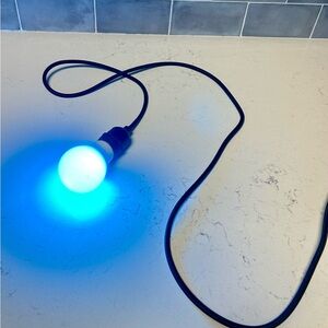 NWOT wall hanging LED Light Bulb with Black Cord plugs 🔌 in to wall.